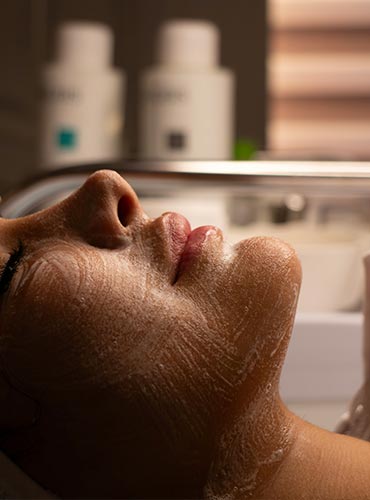 womans-face-with-cleansing-foam-during-facial-treatment-Unsplash - photo by kimia kazemi